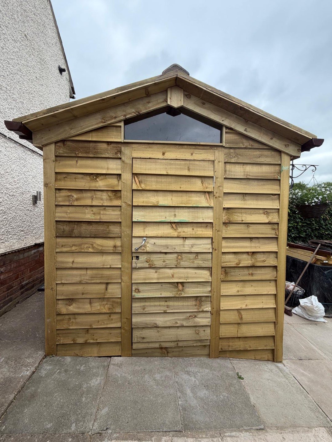 Bespoke timber garden store with apex roof built from pressure-treated cladding