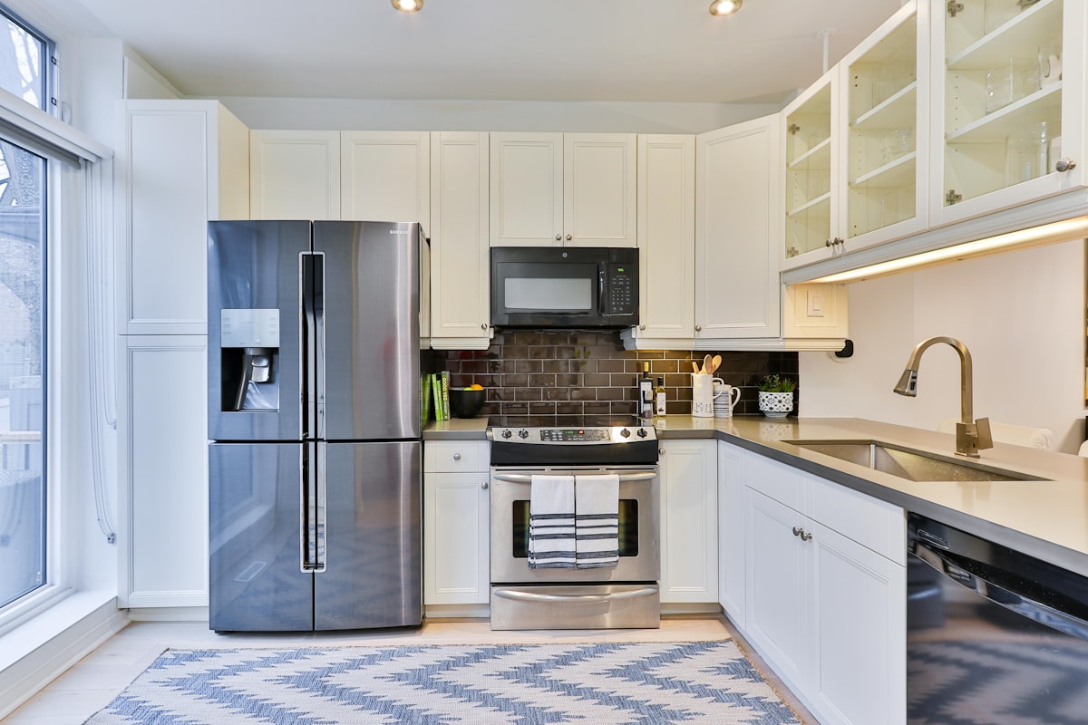 Open plan kitchen renovation with navy shaker units